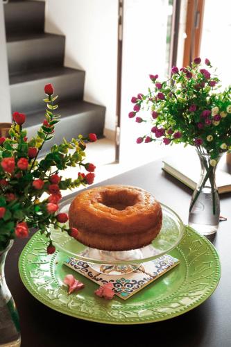 a green plate with a donut on a table at Masseria Specchiulla in Otranto
