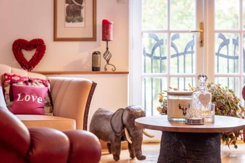 a living room with a couch and a table at Stunning Luxury Duplex with Hot Tub and AirCon in Glenfarg