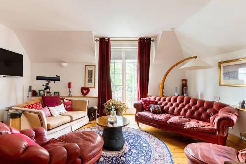 uma sala de estar com dois sofás e uma mesa em Stunning Luxury Duplex with Hot Tub and AirCon em Glenfarg