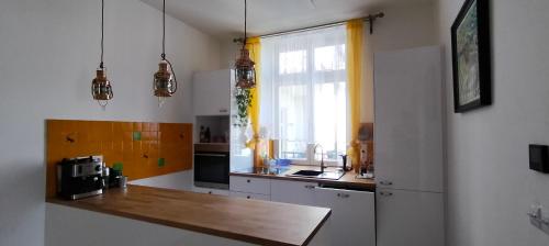 a kitchen with a counter and a sink and a window at Apartment Spielberk in Brno