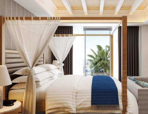a bedroom with a large bed and a large window at Amanti, MadeForTwo Hotels - Ayia Napa in Ayia Napa