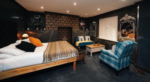 a bedroom with a bed and a chair at The Rokxy Townhouse & Residences - Kings Cross in London