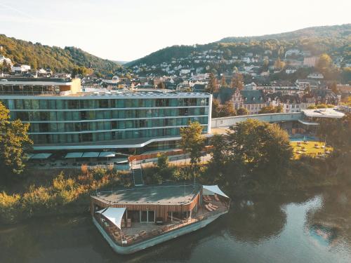 a boat in the water in front of a building at Emser ThermenHotel in Bad Ems