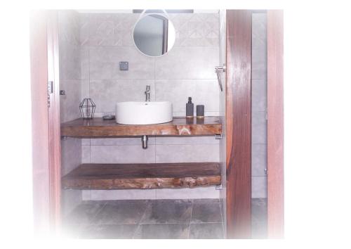 a bathroom with a sink and a mirror at Perle de Riambel in Riambel