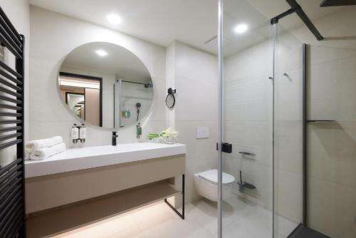 a bathroom with a sink and a glass shower at LUA Resort - Adults only in Balatonfüred