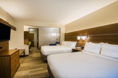 a hotel room with two beds and a flat screen tv at Holiday Inn Express Hotel & Suites Cedar City by IHG in Cedar City