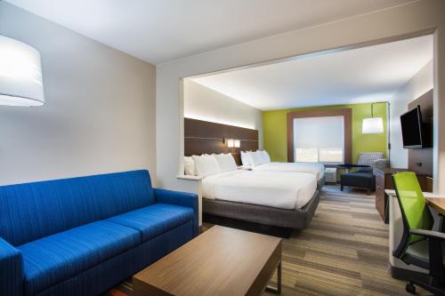 a hotel room with a bed and a couch at Holiday Inn Express Hotel & Suites Cedar City by IHG in Cedar City