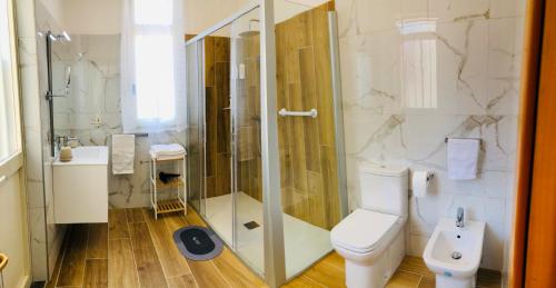 a bathroom with a shower and a toilet and a sink at Casa F. I. in Roccalumera