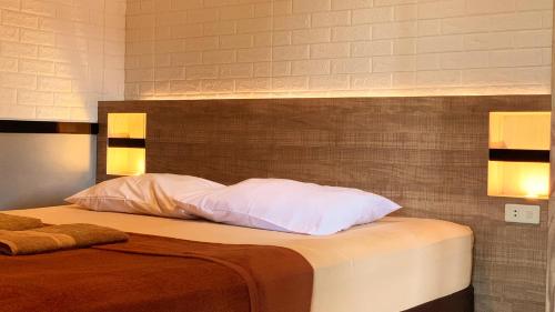 a bedroom with a bed with white pillows at Omah Pelem Syariah in Semarang