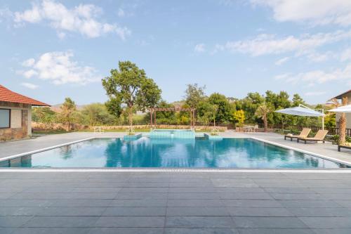 a swimming pool at a resort with at Sarasiruham Resort - Private Pool Villa in Udaipur in Udaipur