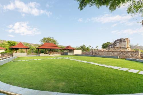 an image of a large lawn in front of a building at Sarasiruham Resort - Private Pool Villa in Udaipur in Udaipur