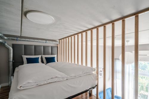 a bedroom with a bed and a large window at RentPlanet - Apartamenty Zarembowicza II in Wrocław