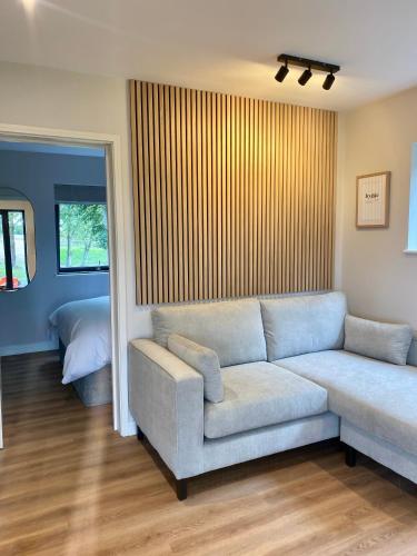 a living room with a couch and a bed at Hygge at Vallum in Newcastle upon Tyne