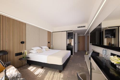 a hotel room with a bed and a kitchen at LUA Resort - Adults only in Balatonfüred