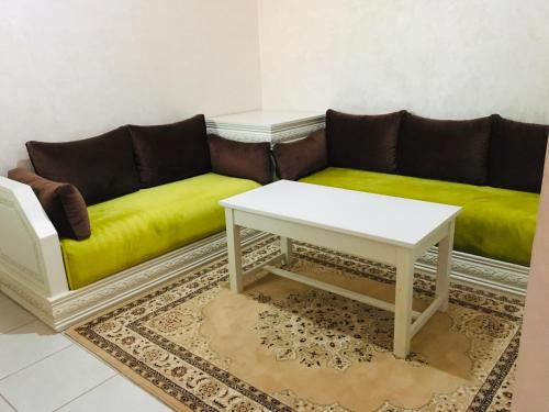 a living room with a couch and a coffee table at Riad Nasma Souihla in Marrakech