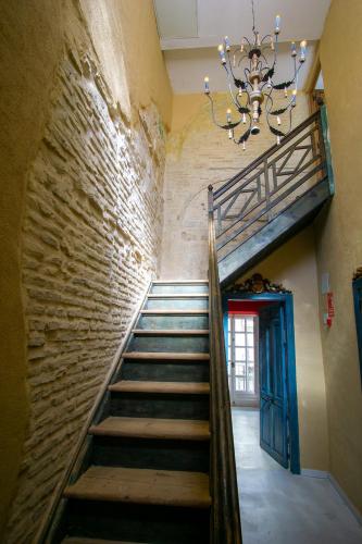 a staircase in an old building with a chandelier at Apartamentos Sharis in Jerez de la Frontera