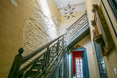 a staircase in a building with a red door at Apartamentos Sharis in Jerez de la Frontera