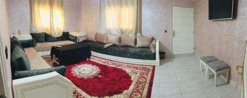 a living room with a couch and a red rug at Riad Nasma Souihla in Marrakech