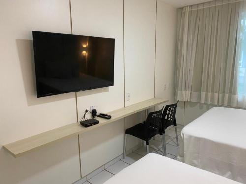 a hotel room with a television on a wall at PONTA NEGRA BEACH - Natal in Natal