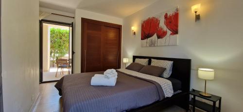 a bedroom with a bed with a white towel on it at Port Pollensa Dream in Port de Pollensa