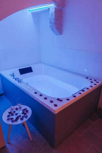 a large bath tub in a room with a stool at Suite Matteotti in Fasano