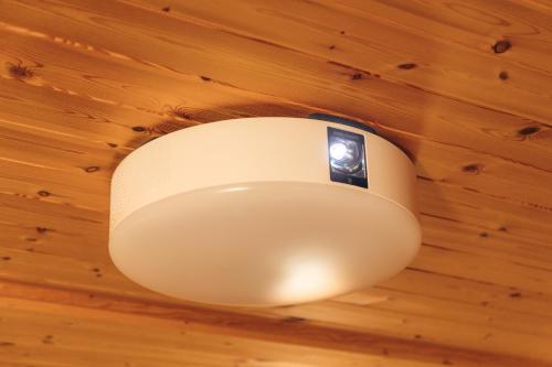 a white light hanging from a wooden ceiling at Sea Forest 南熱海 in Atami