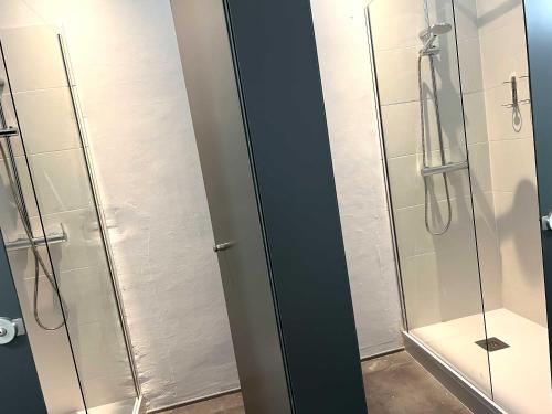 a bathroom with a shower and a glass door at The MO GOTIC in Barcelona