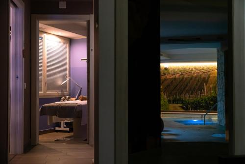 a view of a room with a view of a bed and a window at Wine Hotel San Giacomo Activity & Wellness in Paderno del Grappa