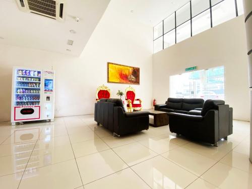 a living room with two couches and a refrigerator at Your Hotel Klang by D'concept in Klang