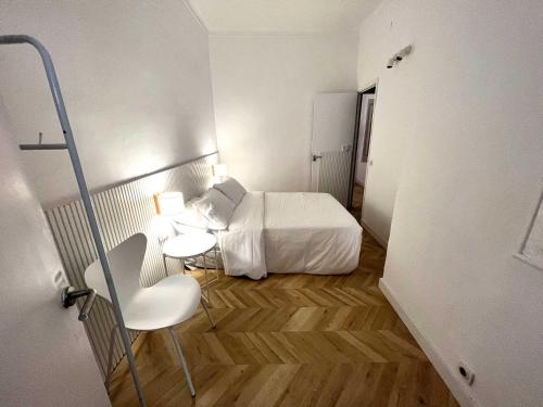 a small room with a bed and a chair in it at The MO GOTIC in Barcelona