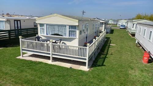 a small house on a porch with a deck at A&P Sheron Holiday Home - The Chase, Ingoldmells, Skegness in Ingoldmells