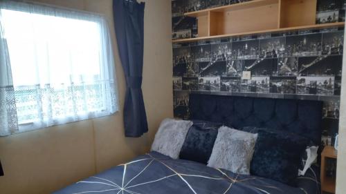a bedroom with a bed and a window at A&P Sheron Holiday Home - The Chase, Ingoldmells, Skegness in Ingoldmells