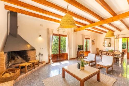 a living room with a fireplace and a table at Sencelles - 3998-03 Mallorca in Sencelles