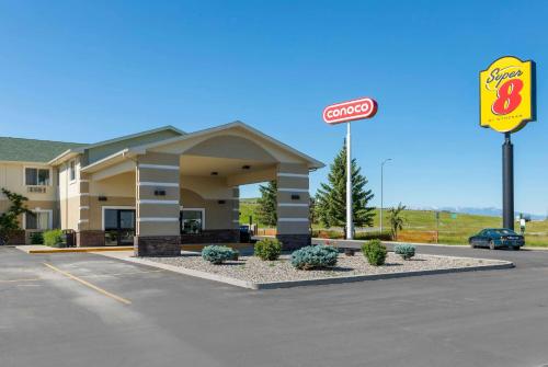 a hotel with a sign in a parking lot at Super 8 by Wyndham Big Timber in Big Timber