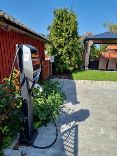 a pay phone is connected to a house at Marių vėjas in Nida
