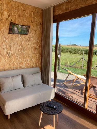 a living room with a couch and a sliding glass door at O REFUXIO DOS CEBREIROS in Mazaricos
