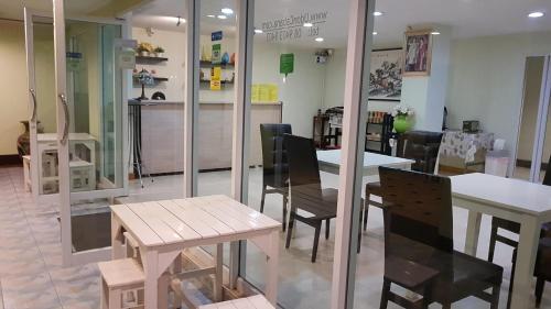a restaurant with tables and chairs in a room at Udoncabana in Udon Thani