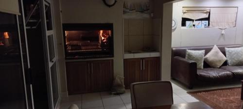 a living room with a couch and a fireplace at Waterfront G8 Swakopmund in Mondesa