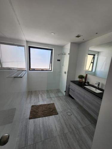 a large bathroom with a sink and a counter at PERTH CBD APARTMENTS in Perth