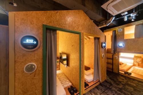 a train with a door open to a room at eeGee STAY Kamata in Tokyo