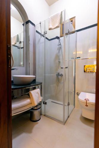 a bathroom with a glass shower and a sink at Sirin Han Hotel Old City in Istanbul