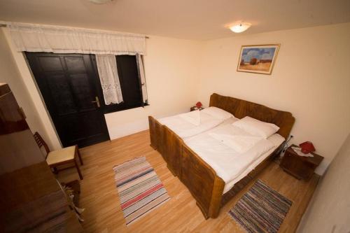 a small bedroom with a bed with a wooden frame at Rooms with a parking space Tordinci, Slavonija - 15159 in Tordinci