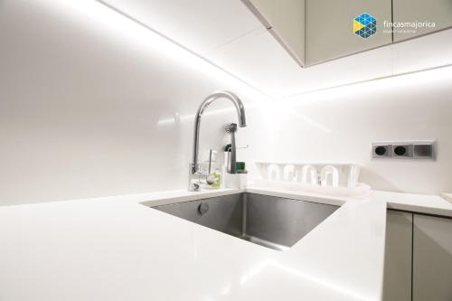 a kitchen with a sink in a white kitchen at Apartamento Beach Cala Pi in Cala Pi