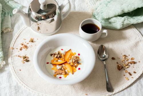 een bord met een kom eten en een kop koffie bij Can Mascort Eco Hotel in Palafrugell