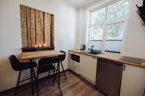 a small kitchen with a table and two chairs at Centre Premium in Pärnu