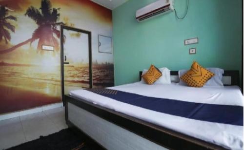 a bedroom with a bed with a picture of a beach at Hotel Classic Gold By WB Inn in Agra