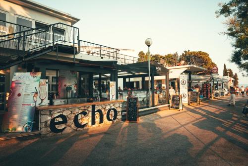 a group of shops on the side of a street at "Echo" B&B rooms, boutique beach hotel in Rabac