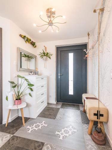 a room with a black door and a white dresser at Ferienwohnungen SIRI in Burgstaedt
