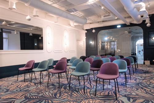 a waiting room with chairs and a mirror at Wellton Riverside SPA Hotel in Rīga