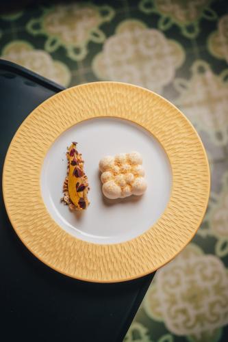 a plate with two pieces of food on a table at Hotel Altus Palace - Destigo Hotels in Wrocław